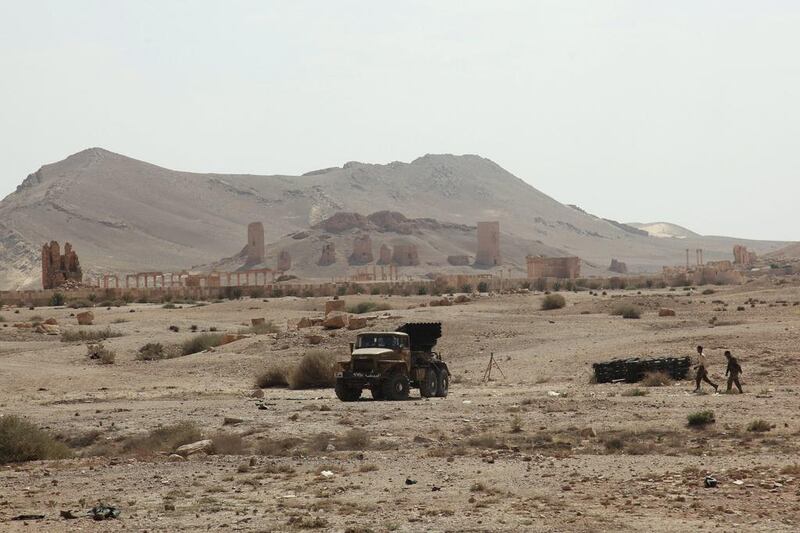 Another 35,000 live in the city’s suburbs. Seen here on May 19, days before its fall, residents walk near a military lorry that belongs to forces loyal to Syria’s president Bashar Al Assad, near the historical city of Palmyra. Reuters