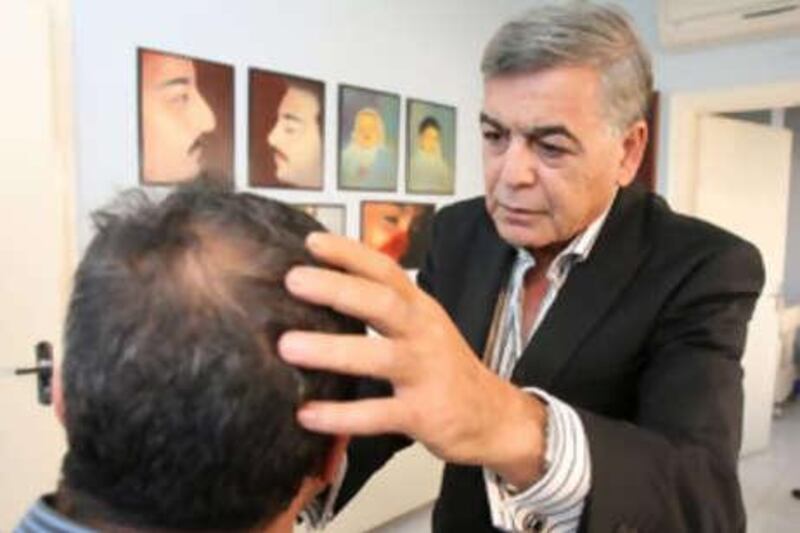 Abdul Salam Abulfailat examines a patient for plastic surgery.