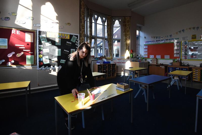 Teacher Miss Galluzzo prepares a school desk at Astbury St Mary's Church of England Primary Schoo in Congleton. Getty Images