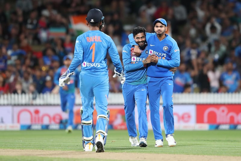 Ravindra Jadeja, centre, and Shreyas Iyer celebrate the wicket of New Zealand’s Colin Munro. AFP