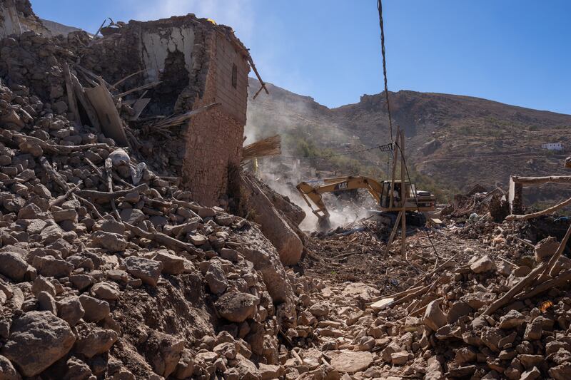 An excavator digs through the rubble of collapsed buildings in Douzrou, Morocco. Getty Images