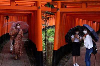 Tourists wear protective face masks at the Fushimi Inari Taisha shrine, one of Japan's most popular tourist destinations. Getty Images
