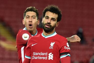 Soccer Football - Premier League - Liverpool v Tottenham Hotspur - Anfield, Liverpool, Britain - December 16, 2020 Liverpool's Mohamed Salah celebrates scoring their first goal with Roberto Firmino Pool via REUTERS/Peter Powell EDITORIAL USE ONLY. No use with unauthorized audio, video, data, fixture lists, club/league logos or 'live' services. Online in-match use limited to 75 images, no video emulation. No use in betting, games or single club /league/player publications. Please contact your account representative for further details.