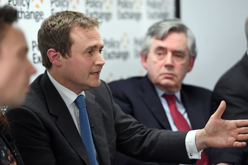 Tom Tugendhat is watched by former British prime minister Gordon Brown at the launch of a bipartisan report titled 'The Cost of Doing Nothing', co-authored by the late Jo Cox MP, at the Policy Exchange in Westminster in 2017. Getty 