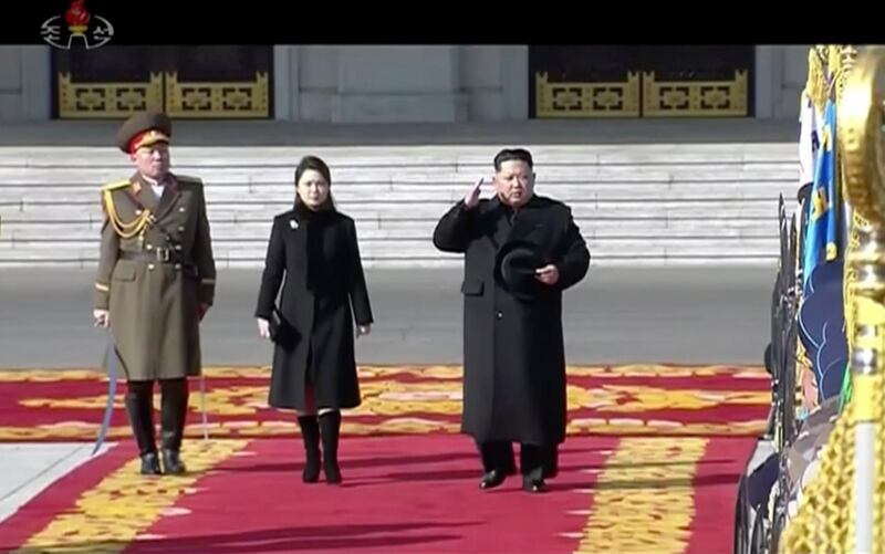 Kim Jong Un inspects honour guards, along with his wife Ri Sol Ju, center,  during a military parade in Pyongyang, KRT / AP