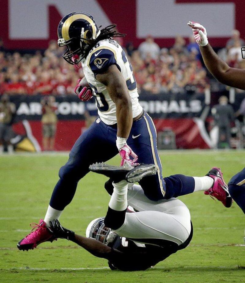St Louis Rams running back Todd Gurley jumps over an Arizona Cardinals defender in his team's NFL victory last weekend. Ross D Franklin / AP / October 4, 2015 