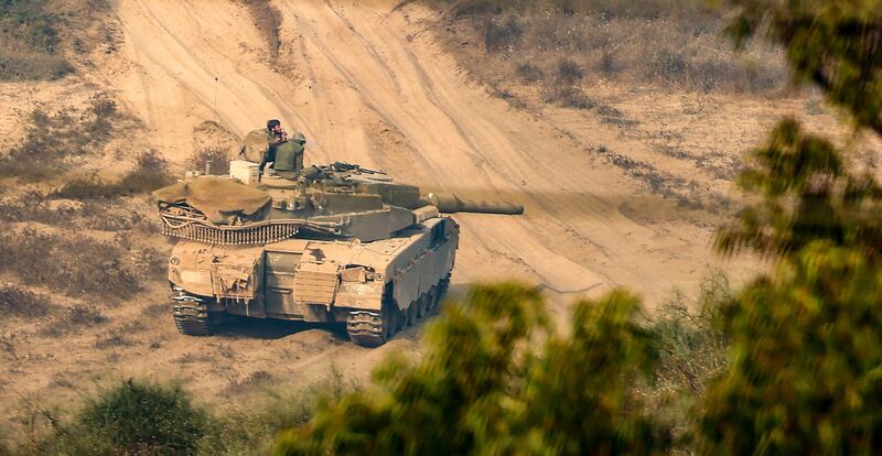 The crew of an Israeli tank prepare for ground operations near the border with Gaza. EPA