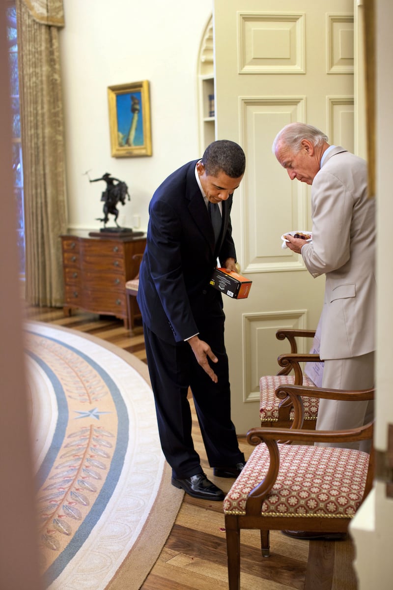 Mr Obama jokingly scolds then-vice president Joe Biden for dropping birthday cake in the Oval Office of the White House.  Photo courtesy of the National Archives