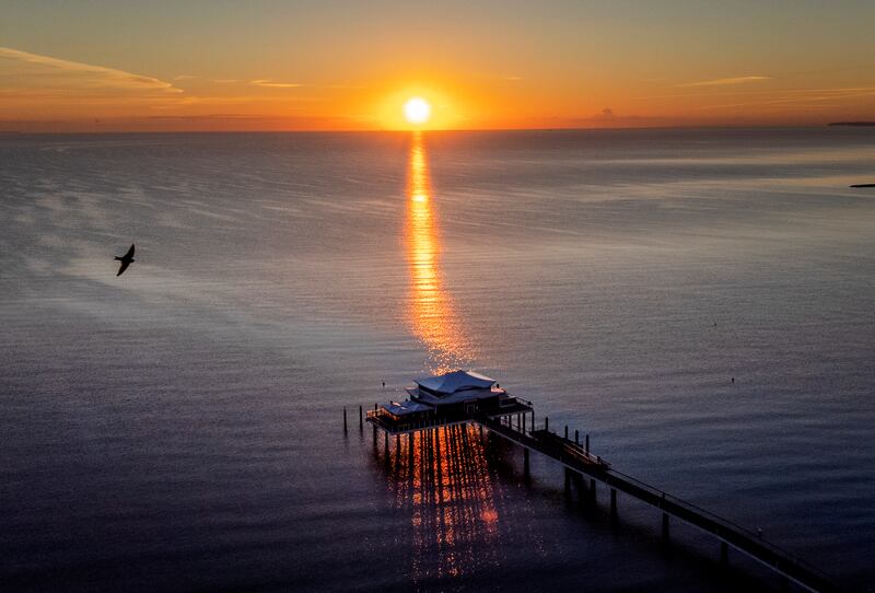 The sun rises over the Baltic Sea and a pier with a tea house in Timmendorfer Strand, Germany. AP Photo