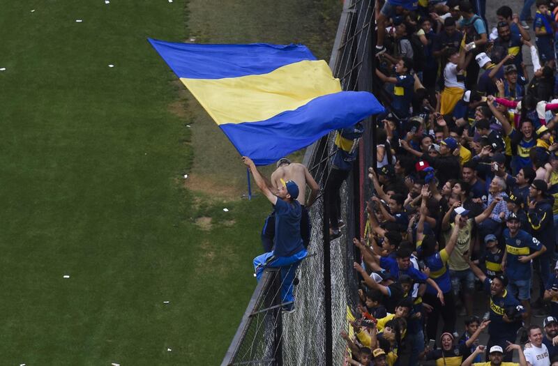 A Boca Juniors fan waves the team flag during an open training session inside La Bombonera ahead of the Copa Libertadores final second leg. Getty Images
