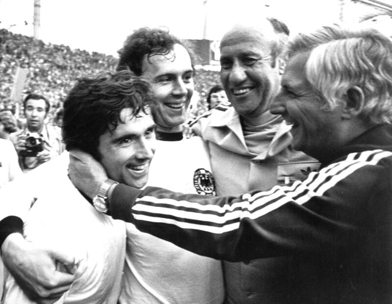 Coach Helmut Schon, his assistant Jupp Derwall, goalscorer Gerd Muller and team captain Franz Beckenbauer celebrate winning the 1974 World Cup 1974.