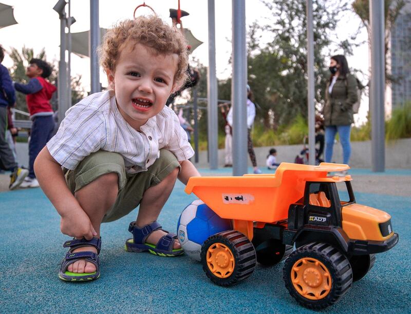 Abu Dhabi, United Arab Emirates, January 21, 2021.  Charlie, 2, plays with his truck at the kiddie play area in Al Fay Park on Reem Island.
Victor Besa/The National 
Section:  LF
Reporter: Panna Munyal