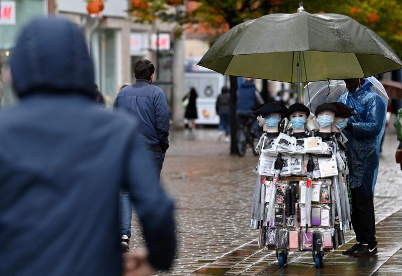 A street seller stands with his stall selling protective face masks in Manchester. AFP