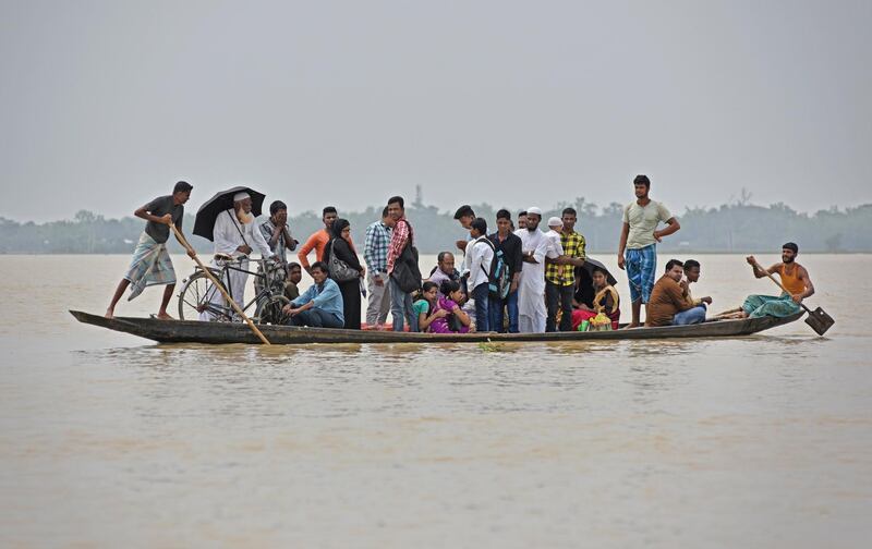 Flood affected villagers are transported in a boat to a safer place in Hojai district, in the northeastern state of Assam, India. Anuwar Hazarika / Reuters