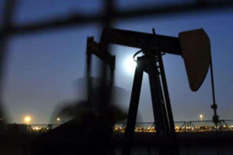 An oil pump works in the November moonlight in Bahrain oilfields.