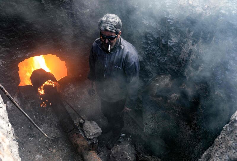 A man works at a makeshift oil refinery near the village of Tarhin. Many amateur refineries have sprung up in Syria since civil war broke out in 2011. AFP