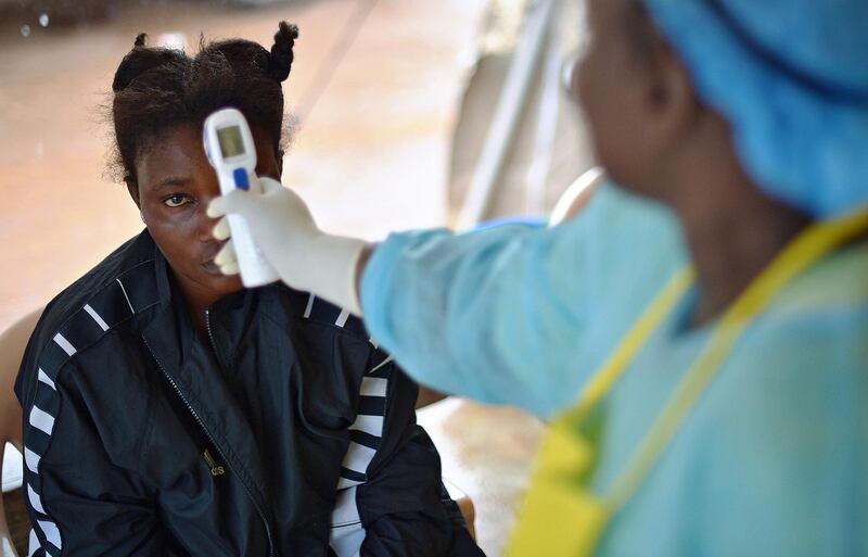 A girl suspected of being infected with the Ebola virus has her temperature checked at the government hospital in Kenema on August 16, 2014. AFP