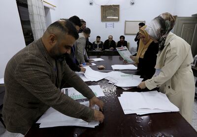 Officials sort ballot papers after the closing of the polling station during Iraq's provincial council elections in Kirkuk. Reuters