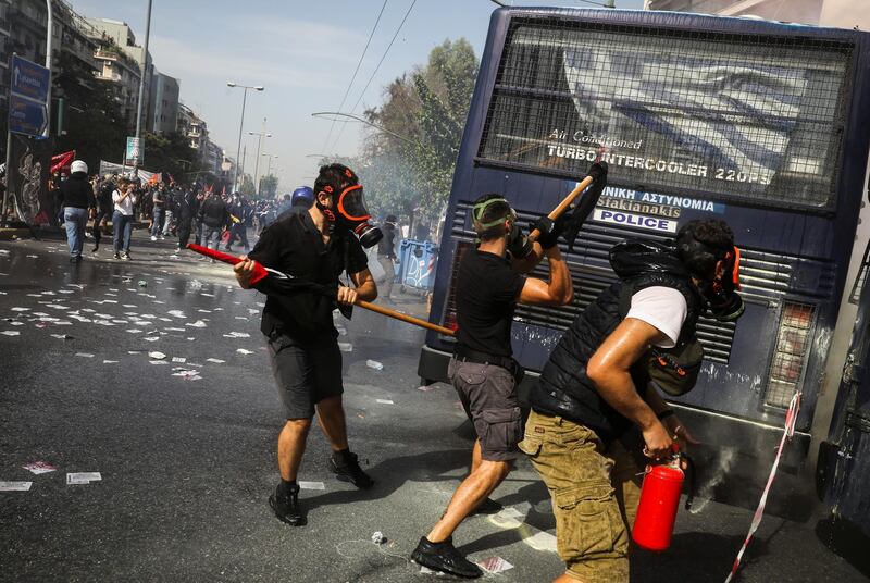 Protesters hit a police vehicle during clashes outside the court. Reuters