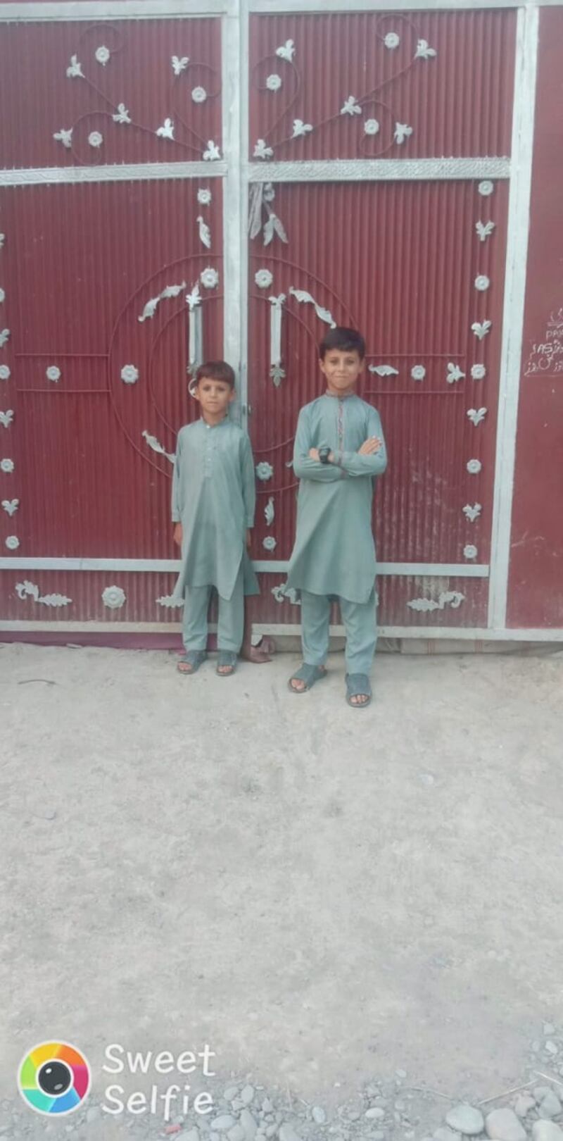 Mukhsin, 7, Mamoor Khan's youngest son, stands with his brother Hakimullah, 9, in one of the pictures shared by the terrorist victim's family.