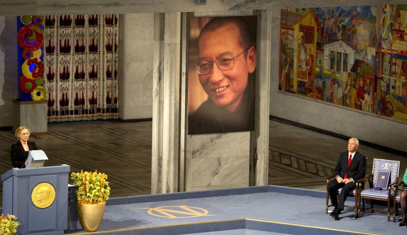 Norwegian actress Liv Ullmann (L) reads Liu Xiaobo's text "I have no enemies" next to the The Nobel Peace Prize committee Chairman Thorbjoern Jagland (R) sitting next to an empty chair at  the ceremony for the Nobel Laureate and dissident Liu Xiaobo at the city hall in Oslo, on December 10, 2010. With the guest of honour stuck in a Chinese prison, this year's Nobel Peace Prize ceremony centred around an empty chair, as its celebration of dissident Liu Xiaobo continues to split the global community and infuriate Beijing.  AFP PHOTO/ODD ANDERSEN / AFP PHOTO / ODD ANDERSEN