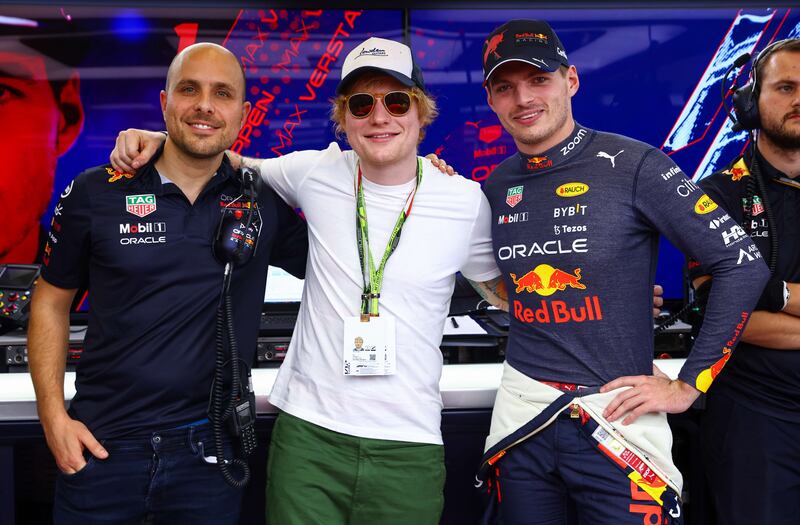 Ed Sheeran poses for a photo with Max Verstappen of Red Bull, right, and Red Bull Racing race engineer Gianpiero Lambiase. AFP