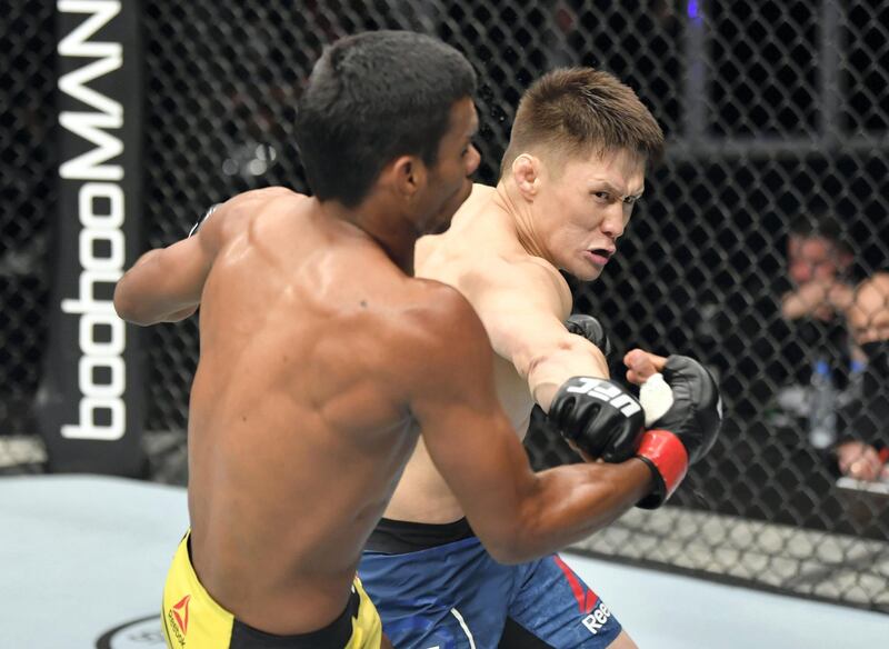 ABU DHABI, UNITED ARAB EMIRATES - JULY 12: (R-L) Zhalgas Zhumagulov of Kazakhstan punches Raulian Paiva of Brazil in their flyweight fight during the UFC 251 event at Flash Forum on UFC Fight Island on July 12, 2020 on Yas Island, Abu Dhabi, United Arab Emirates. (Photo by Jeff Bottari/Zuffa LLC)