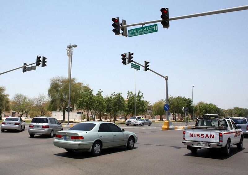 The cameras will watch for cars running red lights, such as these vehicles in Abu Dhabi at the junction of 11th Street and 24th Street. Sammy Dallal / The National