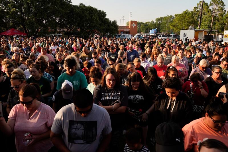 People listen to speakers at a vigil set up close to Santa Fe High School where a gunman shot numerous people in Santa Fe, Texas. Matt Patterson / EPA