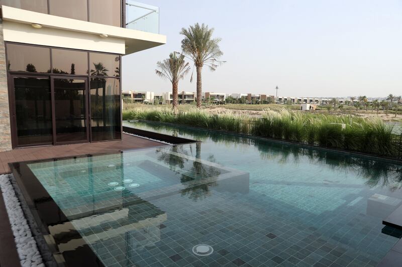 A property in Damac Hills comes with a private pool surrounded by lush greenery