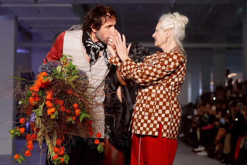Austrian designer Andreas Kronthaler kisses the hand of his wife British designer Vivienne Westwood after the Vivienne Westwood Women's Spring-Summer 2020 Ready-to-Wear collection fashion show in Paris, on September 28, 2019. / AFP / Thomas SAMSON
