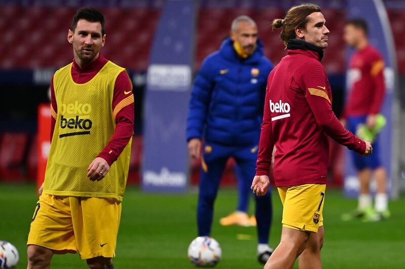 Antoine Griezmann and Lionel Messi warm up before the match between Atletico Madrid and Barcelona at the Wanda Metropolitano. AFP