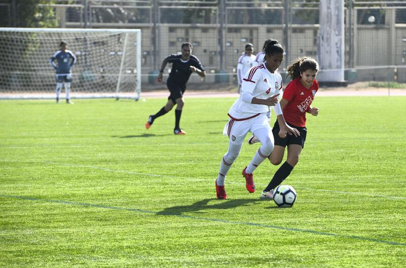 Abu Dhabi, United Arab Emirates - Girls also took part for the first time, Go Pro (red) from Dubai vs. UAE National team (white) under 14 age group on Abu Dhabi World Cup Day 1 at Zayed Sports City. Khushnum Bhandari for The National
