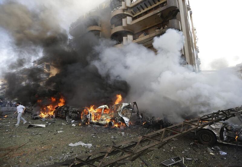 Debris was scattered on the street and cars were on fire as people ran away from the chaotic scene. The second blast was metres away from the embassy. Hussein Malla / AP Photo