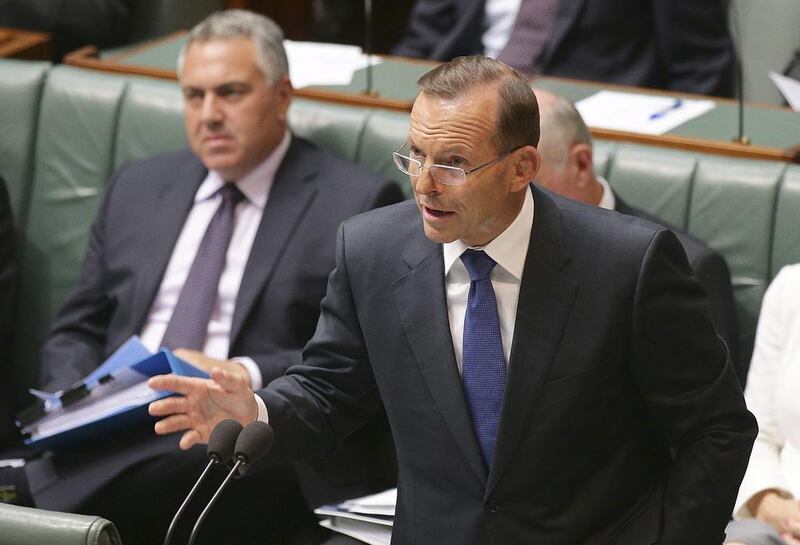 Australia's Prime Minister Tony Abbott speaks about the nation's new anti-extremism strategy during a question time at Parliament House in Canberra, Australia, Monday, Feb. 23, 2015.  Australia will strengthen immigration laws and crack down on groups that incite hatred under a raft of counterterrorism measures introduced Monday in a bid to combat the threat from home-grown terrorists.(AP Photo/Rob Griffith)