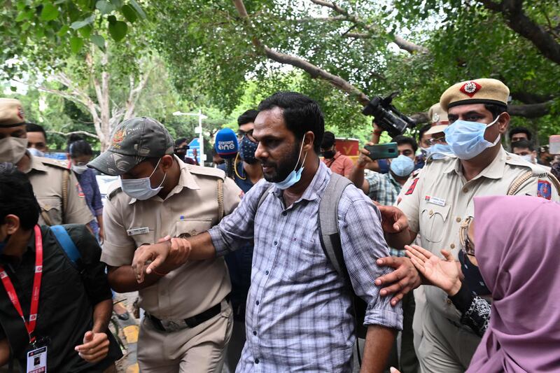 Police officials detain a student activist during a protest outside the Assam Bhawan in New Delhi against a government eviction drive that turned violent and resulted in the deaths of two people in Assam. AFP