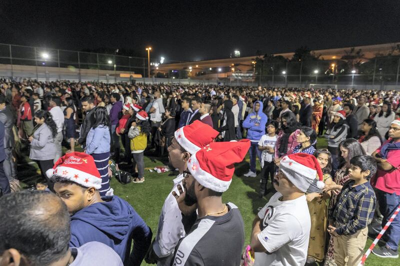 DUBAI, UNITED ARAB EMIRATES. 25 DECEMBER 2019. Midnight Mass at St Mary’s in Dubai to celebrate Christmas. The overflow crowd takes to the churches football field to watch the Mass on big screens. (Photo: Antonie Robertson/The National) Journalist: None. Section: National.
