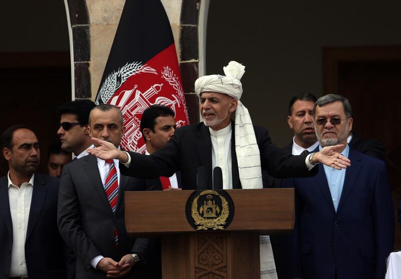 Afghan President Ashraf Ghani, center, speaks after rockets were fired during his inauguration speech. AP