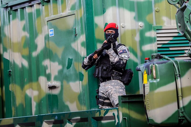 A soldier stands guard outside a temporary military facility. EPA