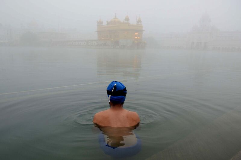 A Sikh takes a dip in the holy sarovar at the Golden Temple in Amritsar, India. Narinder Nanu / AFP Photo