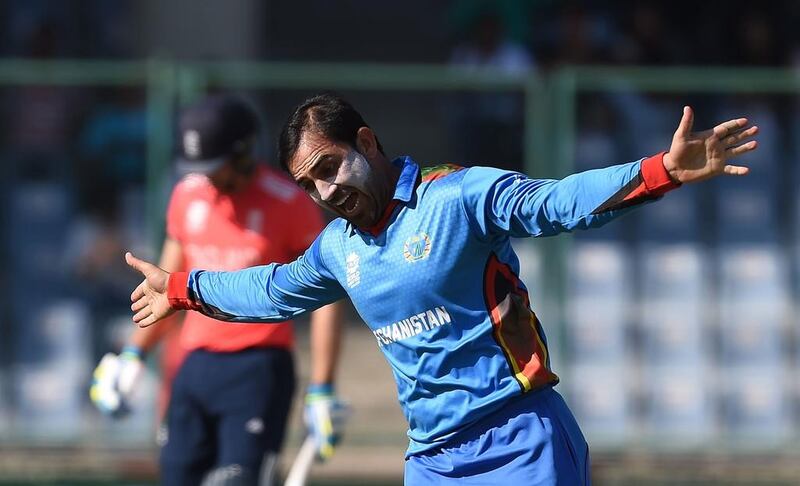 Afghanistan’s Samiullah Shenwari celebrates the wicket of England’s Jos Buttler during the World T20 cricket tournament match between England and Afghanistan at The Feroz Shah Kolta Cricket Stadium in New Delhi. Prakash Singh / AFP