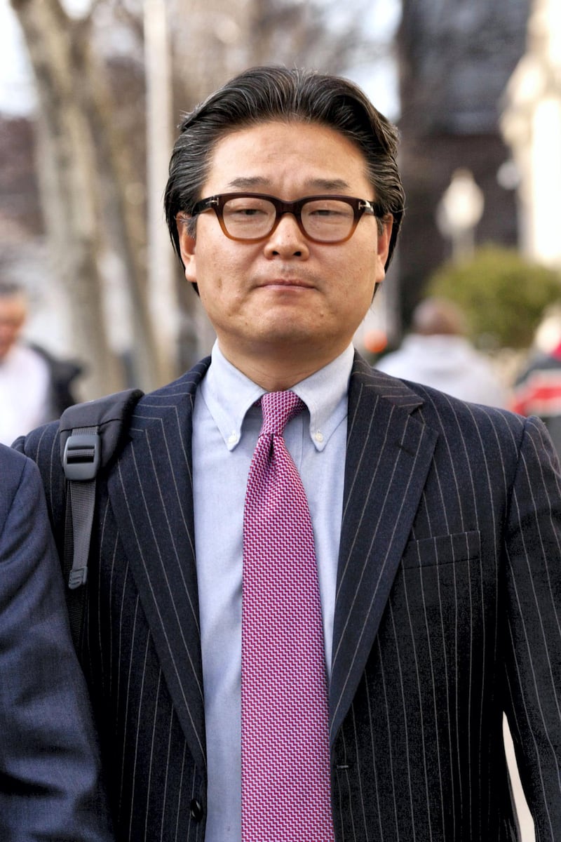 Bill Hwang, founder of Tiger Asia Management LLC, exits federal court in Newark, New Jersey, U.S., on Wednesday, Dec. 12, 2012. Tiger Asia Management LLC, the New York-based hedge fund run by Hwang, pleaded guilty to a wire fraud charge and will forfeit $16.3 million in a U.S. insider-trading case. Photographer: Emile Wamsteker/Bloomberg *** Local Caption *** Bill Hwang