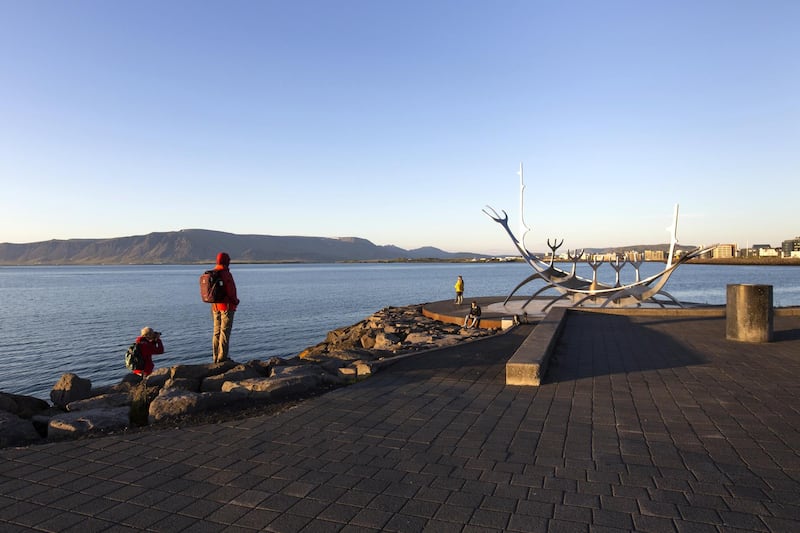 Tourists visit The Sun Voyager (Solfar), a sculpture by Jon Gunnar Arnason, in Reykjavik, Iceland, on Monday, July 20, 2020. Foreigners returned to Iceland on Monday after a hiatus imposed by the Covid-19 outbreak, in a welcome sign for an island nation whose economy is reliant on tourism. Photographer: Sigga Ella/Bloomberg via Getty Images