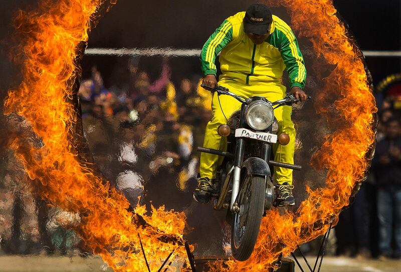 A member of Assam's police force jumps through a ring of fire in Gauhati. Anupam Nath / AP Photo