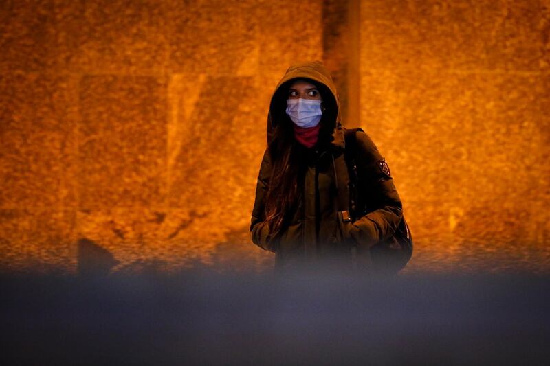 A woman wearing a face mask to help curb the spread of the coronavirus walks leave a subway in Moscow, Russia. Coronavirus infections in Russia have hit a new record as a region in Siberia has shut down some non-essential businesses for two weeks in an effort to curb the spread of the disease.  AP Photo