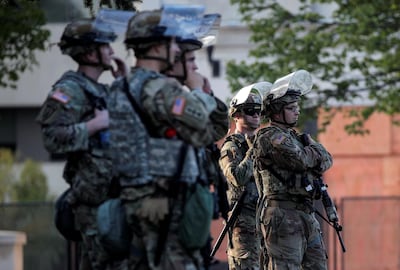 Members of the Wisconsin National Guard stand by as people gather for a vigil, following the police shooting of Jacob Blake, a Black man, in Kenosha, Wisconsin, U.S., August 28, 2020. REUTERS/Brendan McDermid