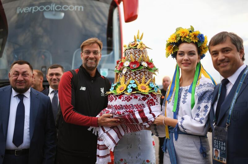 A handout photo made available by the UEFA of Liverpool's manager Juergen Klopp (C-L) receiving a gift as he arrives ahead of the UEFA Champions League final at IEV Airport in Kiev, Ukraine.  EPA / UEFA / HANDOUT