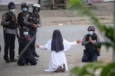 A nun pleads with police not to harm protesters in Myitkyina in Myanmar's Kachin state, AFP/ Myitkyina News Journal