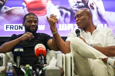 Brazilian-American boxer Anderson Silva (R) shakes hands with American promoter and former professional boxer Floyd Mayweather (L) during a press conference at Dubai Sports Council during the First Global Titans Fight Series at the Helipad of Burj Al Arab luxury hotel in the Gulf emirate of Dubai, United Arab Emirates, 11 May 2022.   EPA / ALI HAIDER