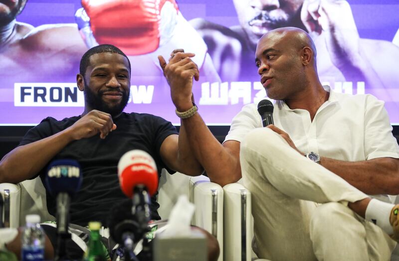 Five-weight former world champion boxer Floyd Mayweather, left, alongside former UFC middleweight champion Anderson Silva, during a press conference at Dubai Sports Council. EPA